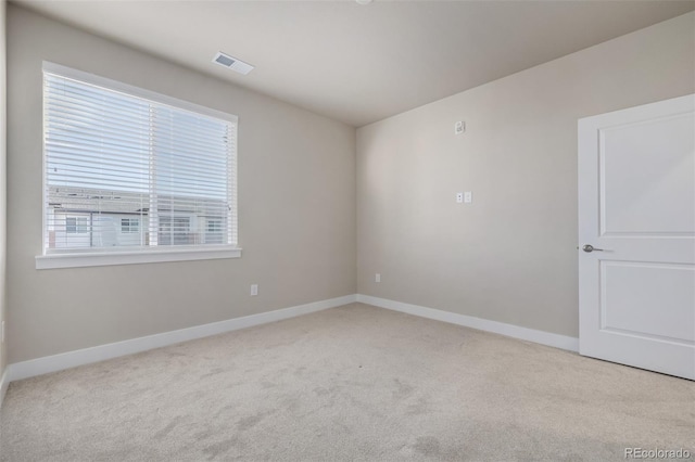 unfurnished room with light colored carpet