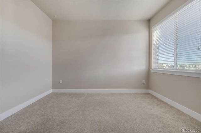 carpeted empty room featuring plenty of natural light