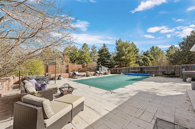 view of pool with an outdoor living space and a patio area