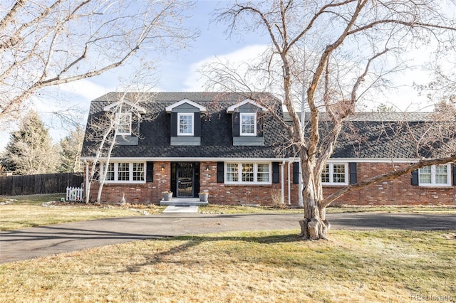 cape cod home with a front yard