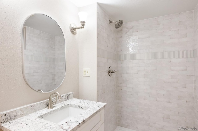 bathroom featuring vanity and a tile shower