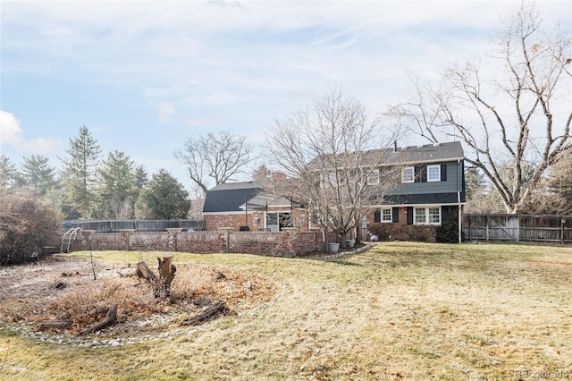 back of house with a yard