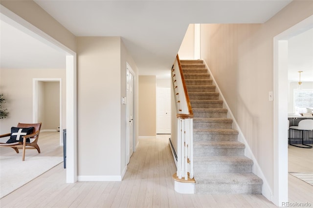 staircase with hardwood / wood-style flooring