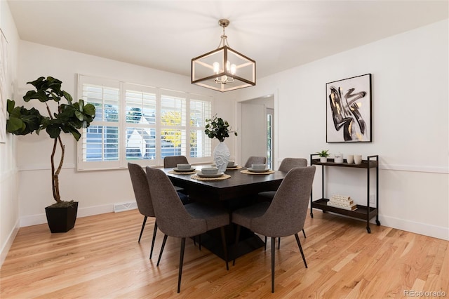 dining area featuring a chandelier and light hardwood / wood-style floors