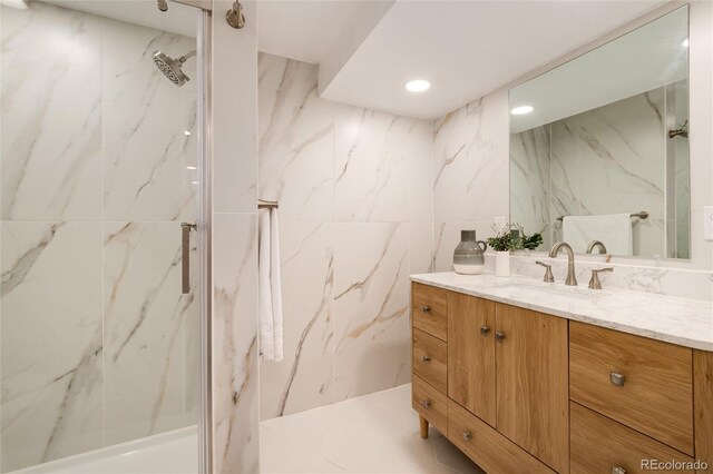 bathroom featuring vanity, tile walls, and walk in shower