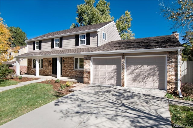 view of property with covered porch and a garage