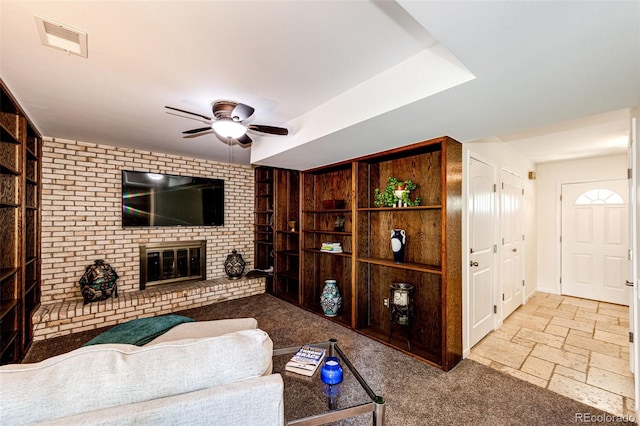 living room with a fireplace and ceiling fan