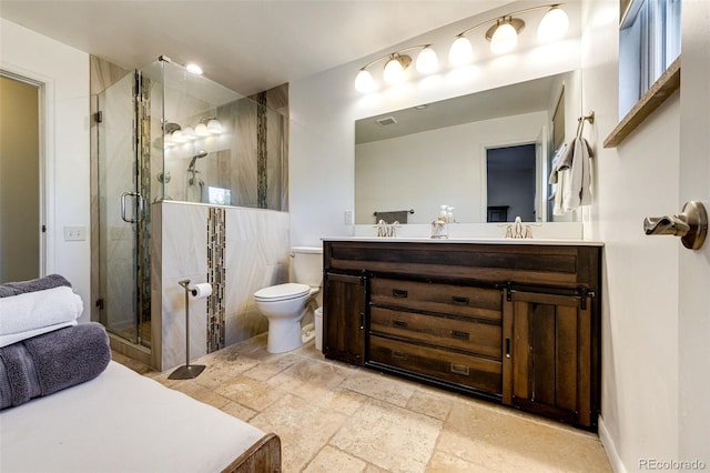 bathroom featuring a shower with door, toilet, and vanity