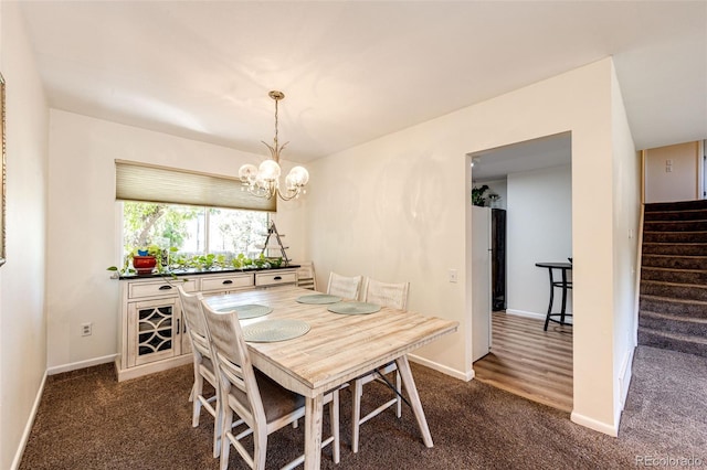 carpeted dining room with an inviting chandelier