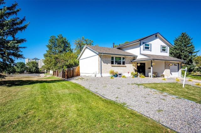 view of front of house featuring a front lawn and a garage