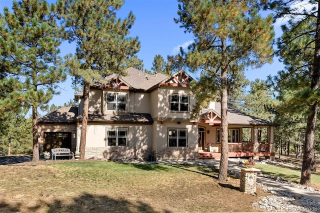 view of front of property featuring a garage, a front lawn, and stucco siding