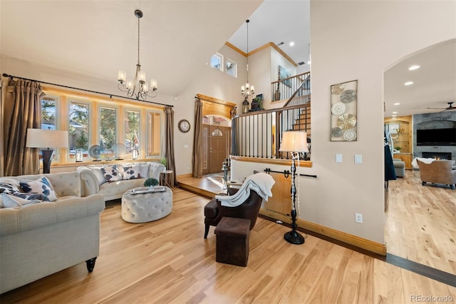 living room featuring stairs, arched walkways, and wood finished floors