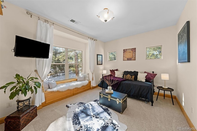 carpeted bedroom featuring visible vents and baseboards