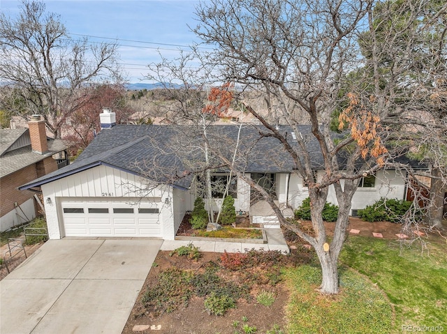 2961 S Rosemary St, Denver, CO 80231 - view of front of home featuring driveway, an attached garage, and a front lawn