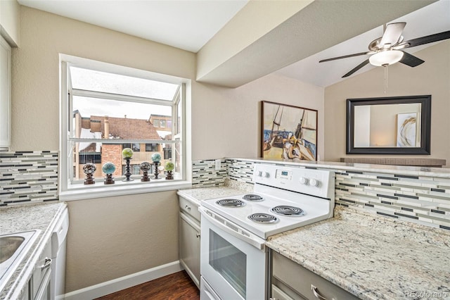 kitchen featuring tasteful backsplash, electric range, light stone countertops, and vaulted ceiling