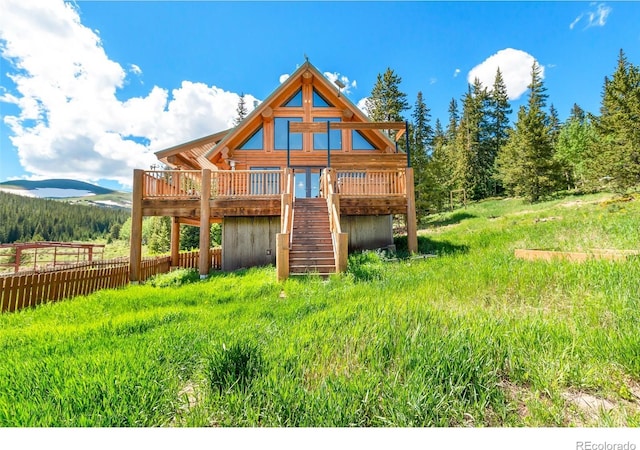 rear view of house with a deck with mountain view