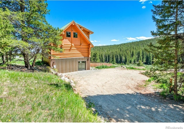 log-style house featuring an outbuilding