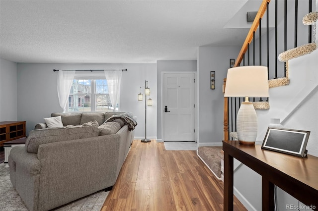 living room with wood-type flooring and a textured ceiling