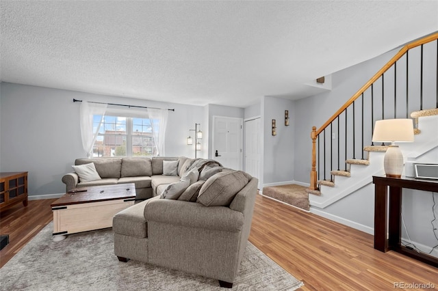 living room featuring hardwood / wood-style flooring and a textured ceiling