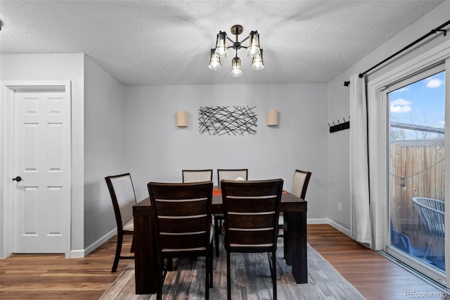 dining area featuring a textured ceiling and hardwood / wood-style flooring