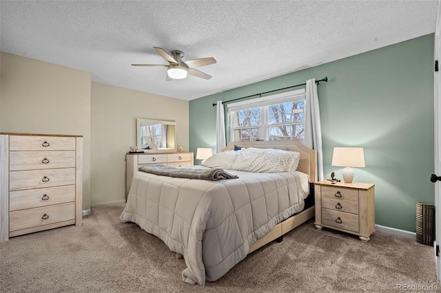 bedroom with ceiling fan, light colored carpet, and a textured ceiling