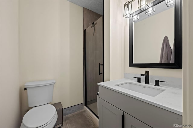 bathroom with a textured ceiling, vanity, an enclosed shower, and toilet