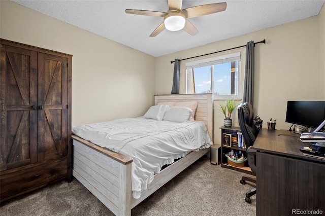 bedroom featuring carpet, ceiling fan, and a textured ceiling