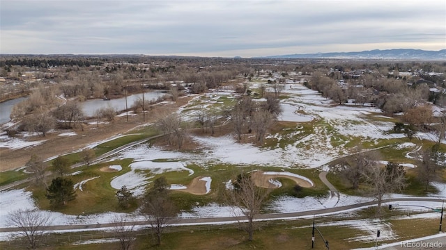 snowy aerial view with a water and mountain view