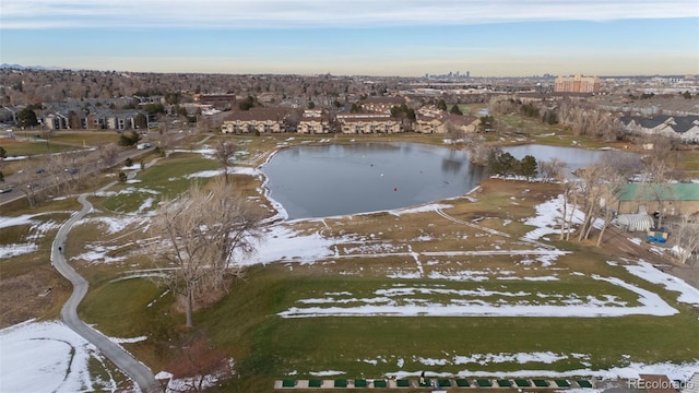 snowy aerial view featuring a water view