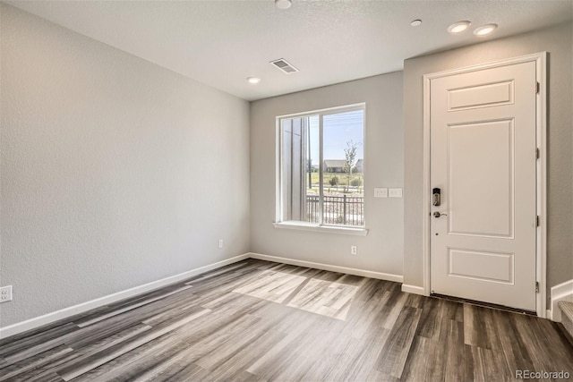 foyer entrance with dark wood-type flooring