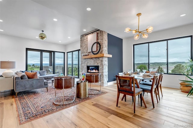 202 October Pl, Castle Rock, CO 80104 - living room featuring light wood-type flooring, a fireplace, a chandelier, and recessed lighting