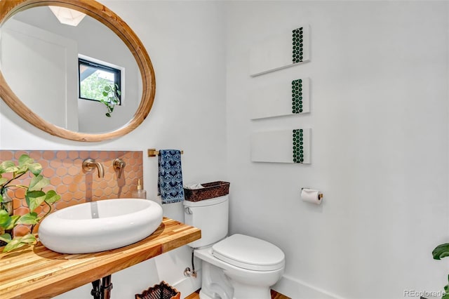202 October Pl, Castle Rock, CO 80104 - half bathroom featuring a sink, toilet, and baseboards