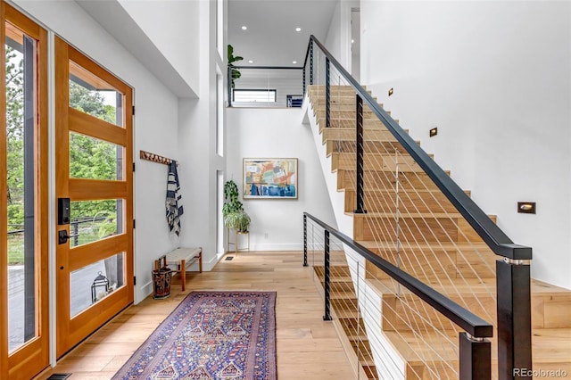 202 October Pl, Castle Rock, CO 80104 - entryway featuring healthy amount of natural light, stairs, light wood-style floors, a high ceiling, and baseboards