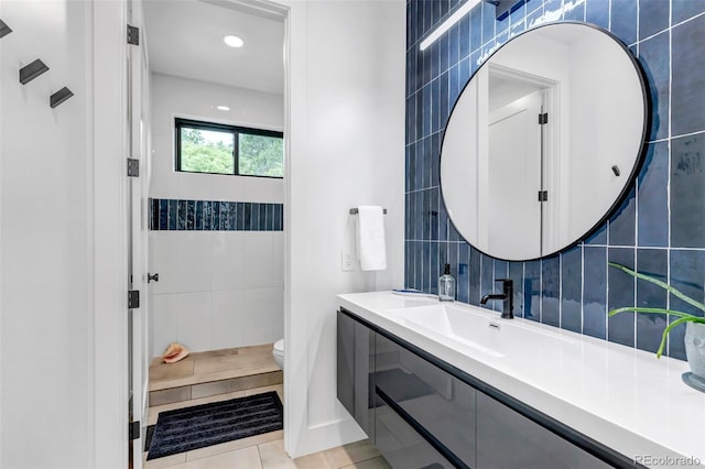 202 October Pl, Castle Rock, CO 80104 - full bath featuring vanity, toilet, tile walls, tile patterned floors, and a tile shower