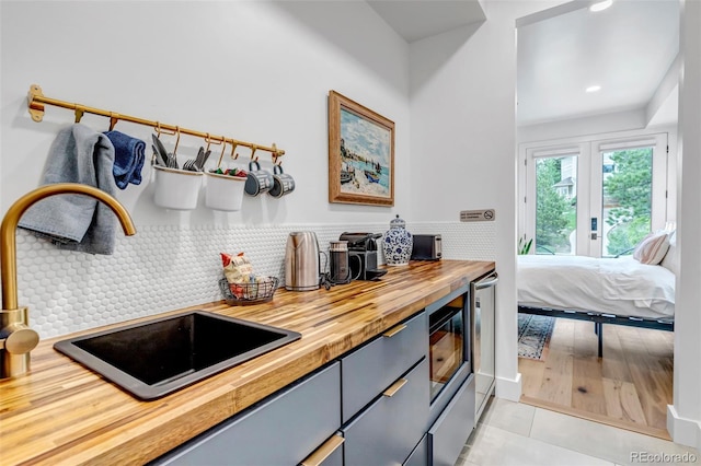 202 October Pl, Castle Rock, CO 80104 - kitchen with wooden counters, a sink, light tile patterned floors, recessed lighting, and decorative backsplash