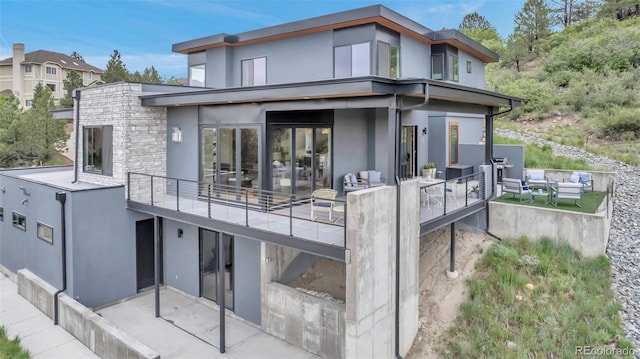 202 October Pl, Castle Rock, CO 80104 - rear view of house featuring a patio, a balcony, stucco siding, and an outdoor living space