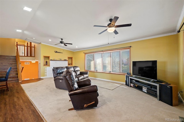 living room with ornamental molding, lofted ceiling, hardwood / wood-style floors, and ceiling fan