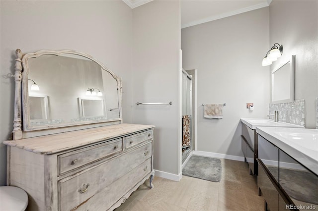 bathroom with vanity, crown molding, and a shower with shower door