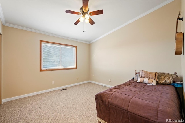 carpeted bedroom with ornamental molding and ceiling fan