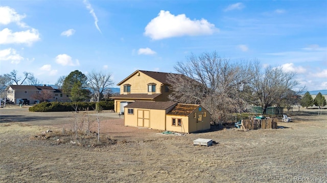 view of side of property featuring a storage unit