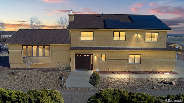 view of front of house featuring solar panels