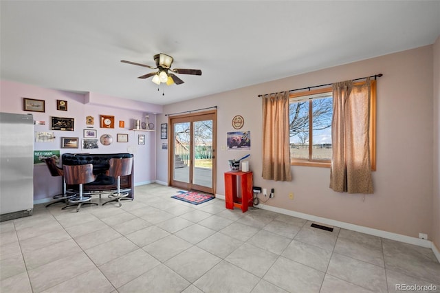 interior space featuring ceiling fan and indoor bar