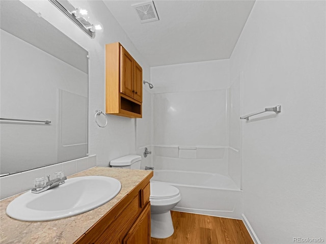 full bathroom featuring vanity, wood-type flooring, bathing tub / shower combination, and toilet