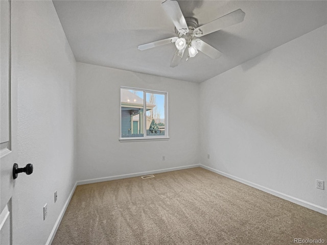 spare room with carpet and ceiling fan