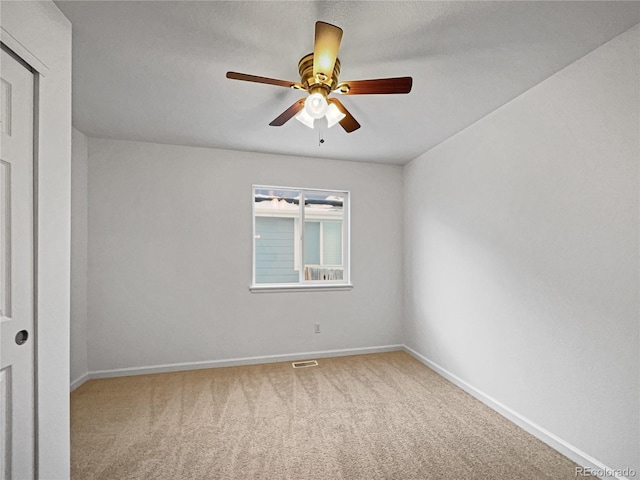 carpeted empty room with ceiling fan