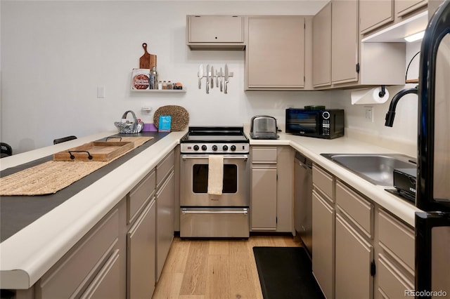 kitchen with gray cabinets, light hardwood / wood-style floors, and appliances with stainless steel finishes