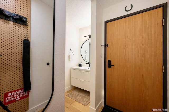 bathroom with vanity and wood-type flooring