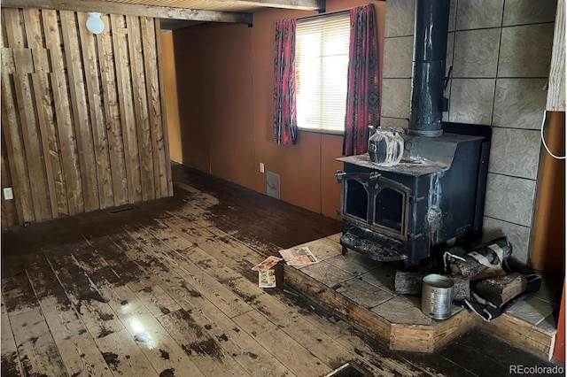 living room with a wood stove and hardwood / wood-style flooring