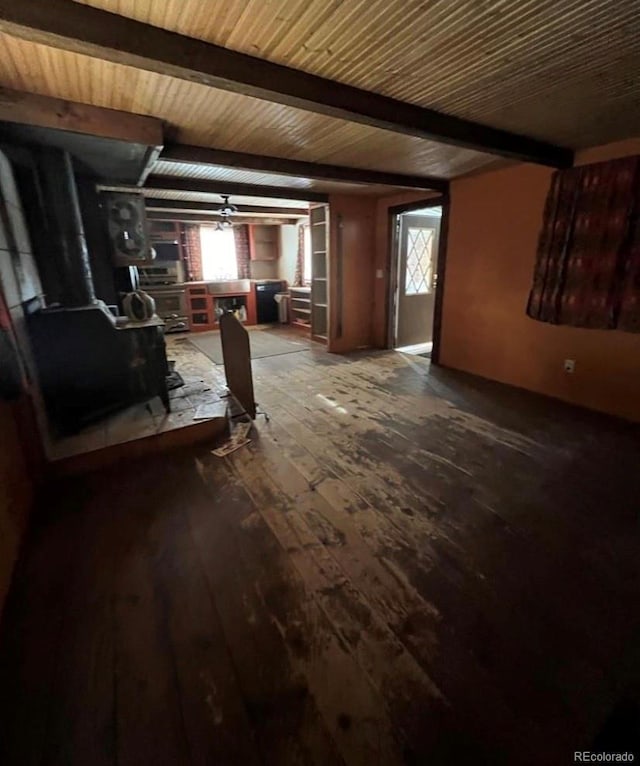 interior space featuring ceiling fan, dark hardwood / wood-style floors, and beam ceiling