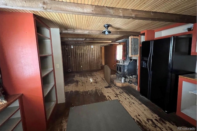 kitchen featuring beamed ceiling, dark hardwood / wood-style floors, and black refrigerator with ice dispenser